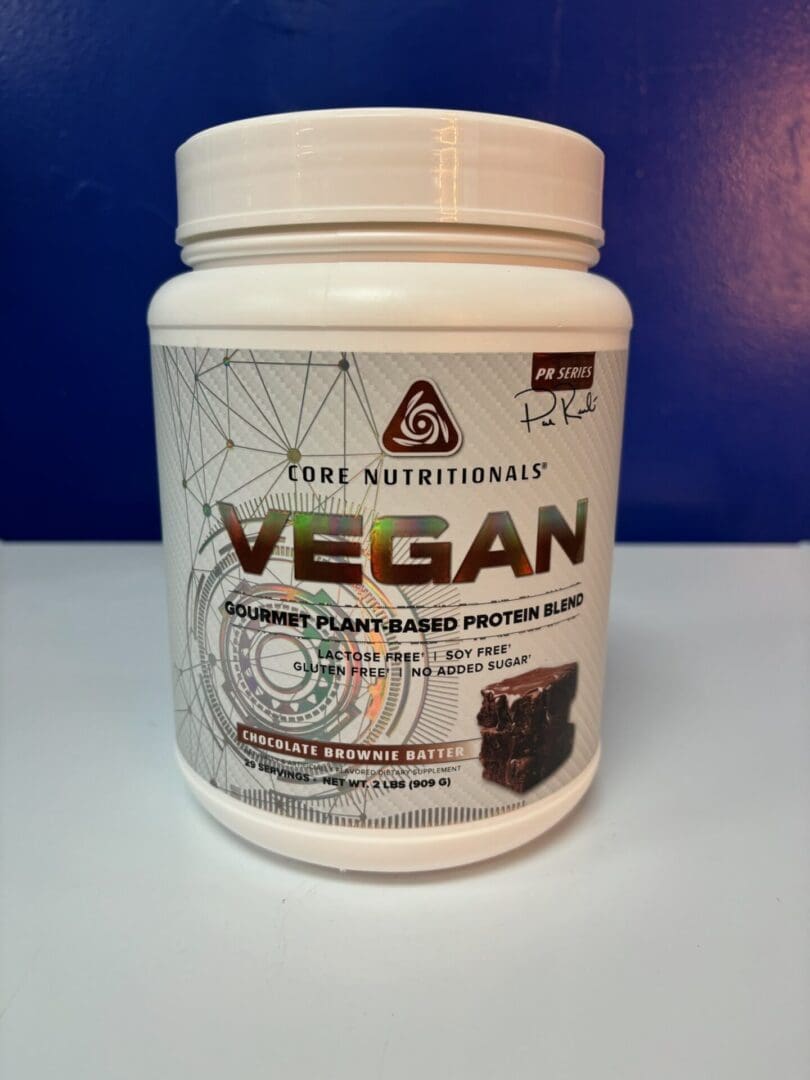 A container of vegan protein is sitting on the counter.