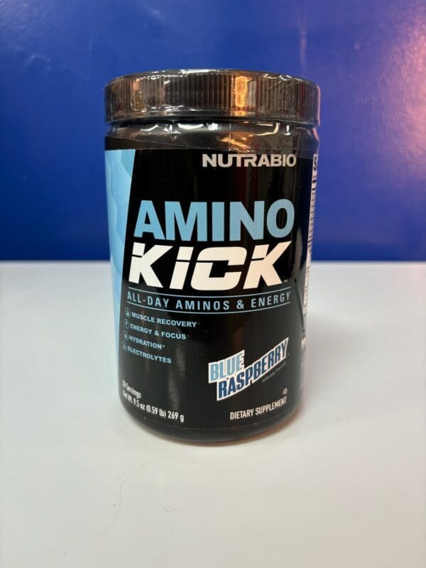 A container of amino kick is sitting on the counter.