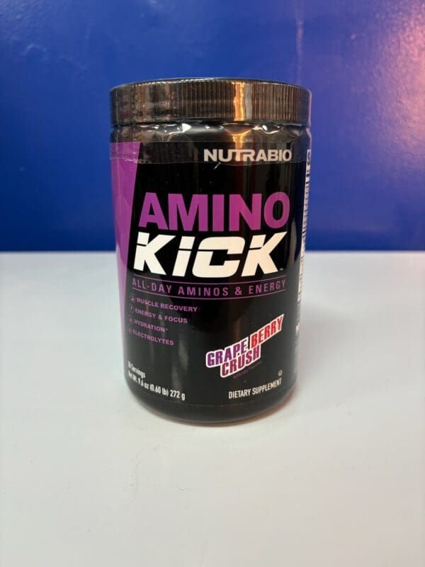 A container of amino kick is sitting on the counter.