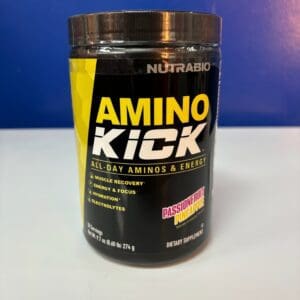 A container of amino kick is sitting on the counter.