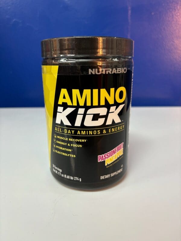 A container of amino kick is sitting on the counter.