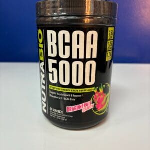 A jar of nutrabio bcaa 5 0 0 0 next to some fruit.