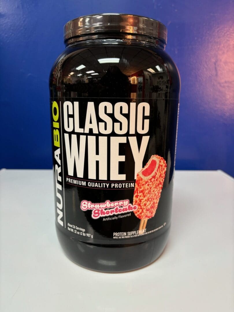 A bottle of classic whey protein on a table.