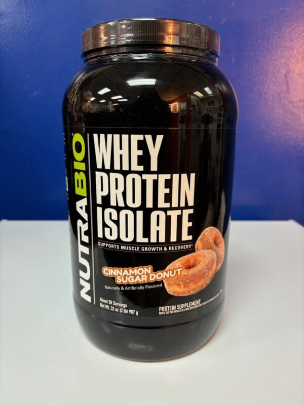 A container of whey protein is sitting on the counter.