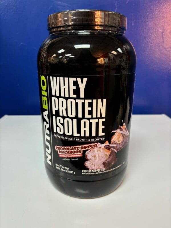 A bottle of whey protein is sitting on the counter.