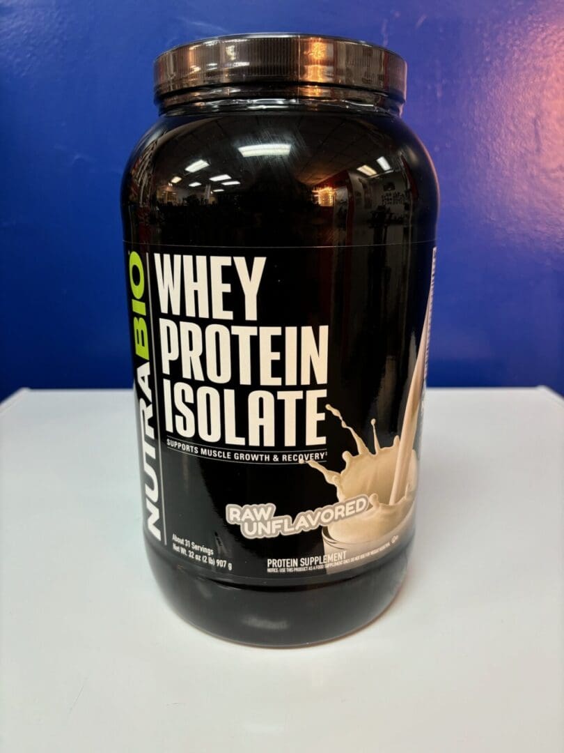 A bottle of whey protein is sitting on the counter.