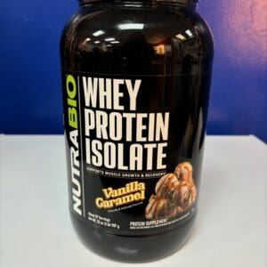 A bottle of whey protein is sitting on the counter.