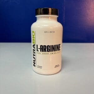 A bottle of l-arginine on top of a table.