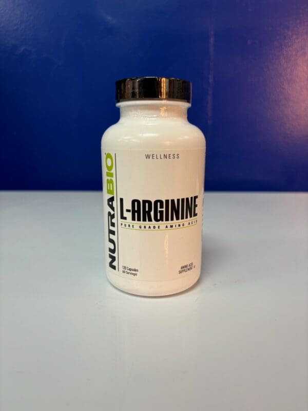 A bottle of l-arginine on top of a table.