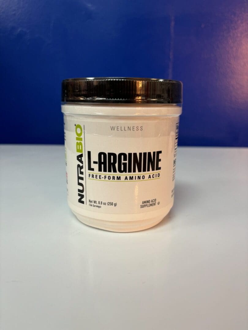 A white container of l-arginine is sitting on the counter.