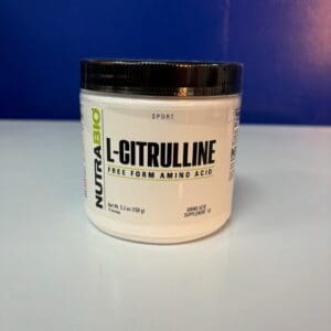 A white container of l-citrulline powder on top of a table.