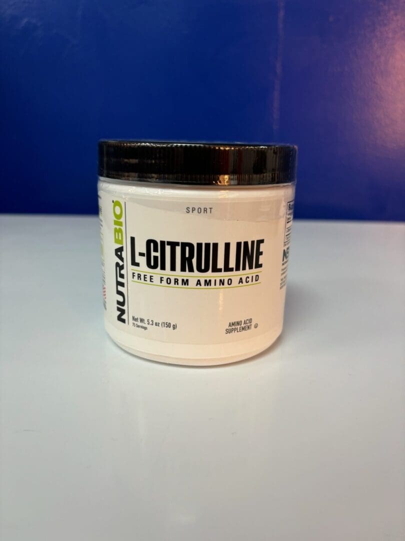 A white container of l-citrulline powder on top of a table.