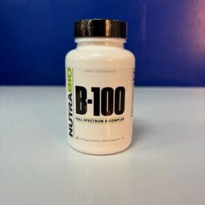 A bottle of vitamin b 1 0 0 is sitting on the table.