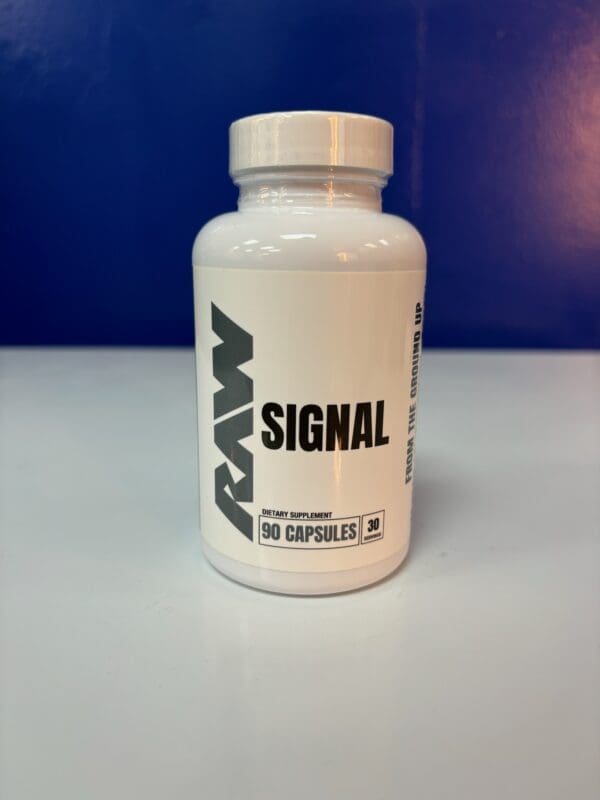 A bottle of raw signal supplement on top of a table.