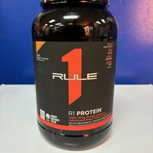 A bottle of rule 1 protein on top of a table.