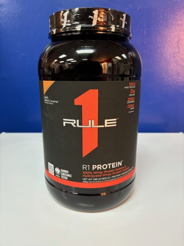 A bottle of rule 1 protein on top of a table.