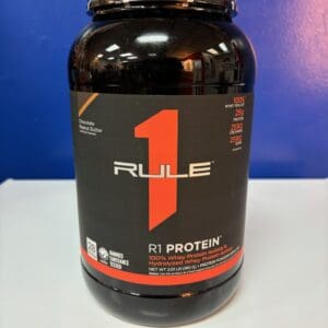 A bottle of rule 1 protein on top of a table.