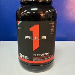 A bottle of rule 1 protein on top of a table.