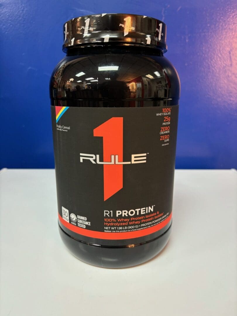 A bottle of rule 1 protein on top of a table.