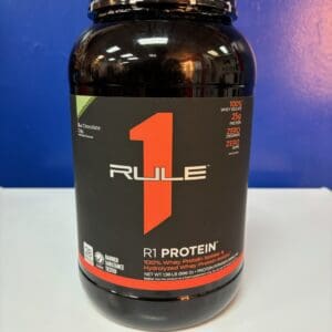 A bottle of rule 1 protein on top of a table.