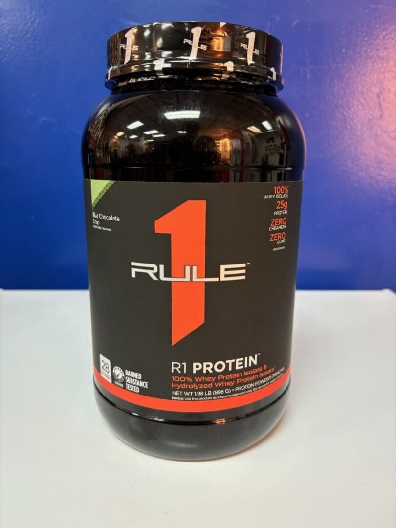 A bottle of rule 1 protein on top of a table.