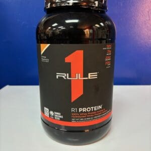 A bottle of rule 1 protein on top of a table.