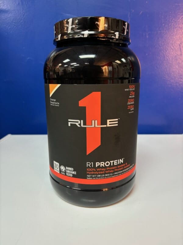 A bottle of rule 1 protein on top of a table.