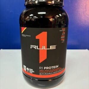 A bottle of rule 1 protein on top of a table.