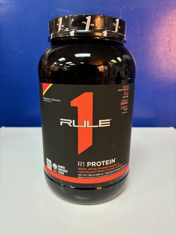 A bottle of rule 1 protein on top of a table.