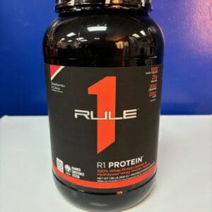 A bottle of protein on top of a table.