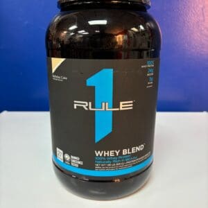 A bottle of rule 1 whey blend on top of a table.