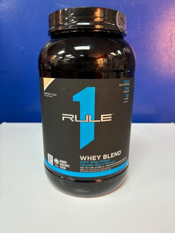 A bottle of rule 1 whey blend on top of a table.