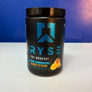 A black container of ryse pre workout is sitting on the counter.