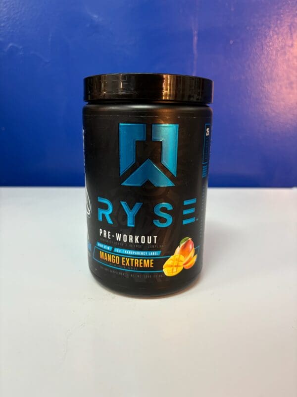 A black container of ryse pre workout is sitting on the counter.